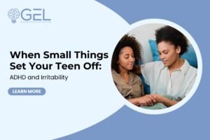 A parent and teen sitting quietly together on a couch in warm evening light after a hard moment has passed, calm and reconnecting.